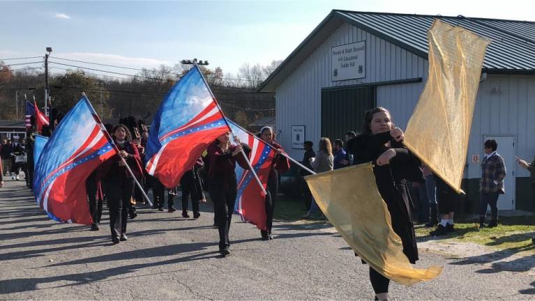 Members of the Color Guard precede the Newton High School marching band.